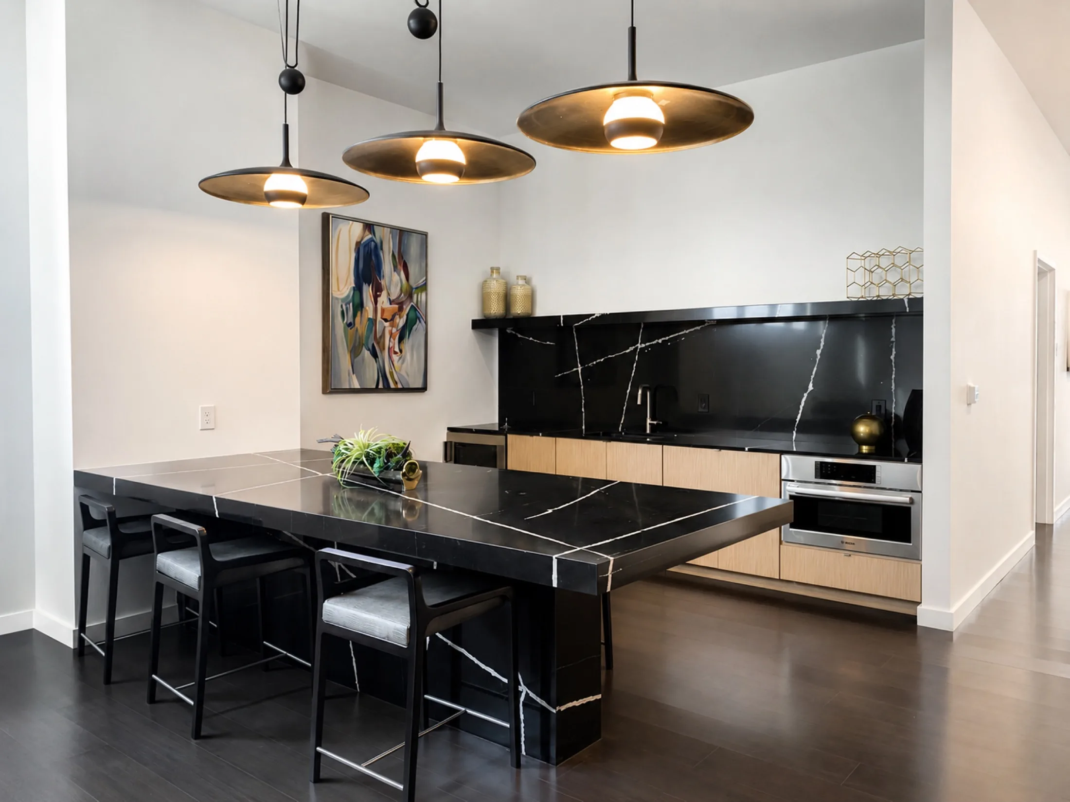 Professionally installed custom black stone and wood kitchen millwork
