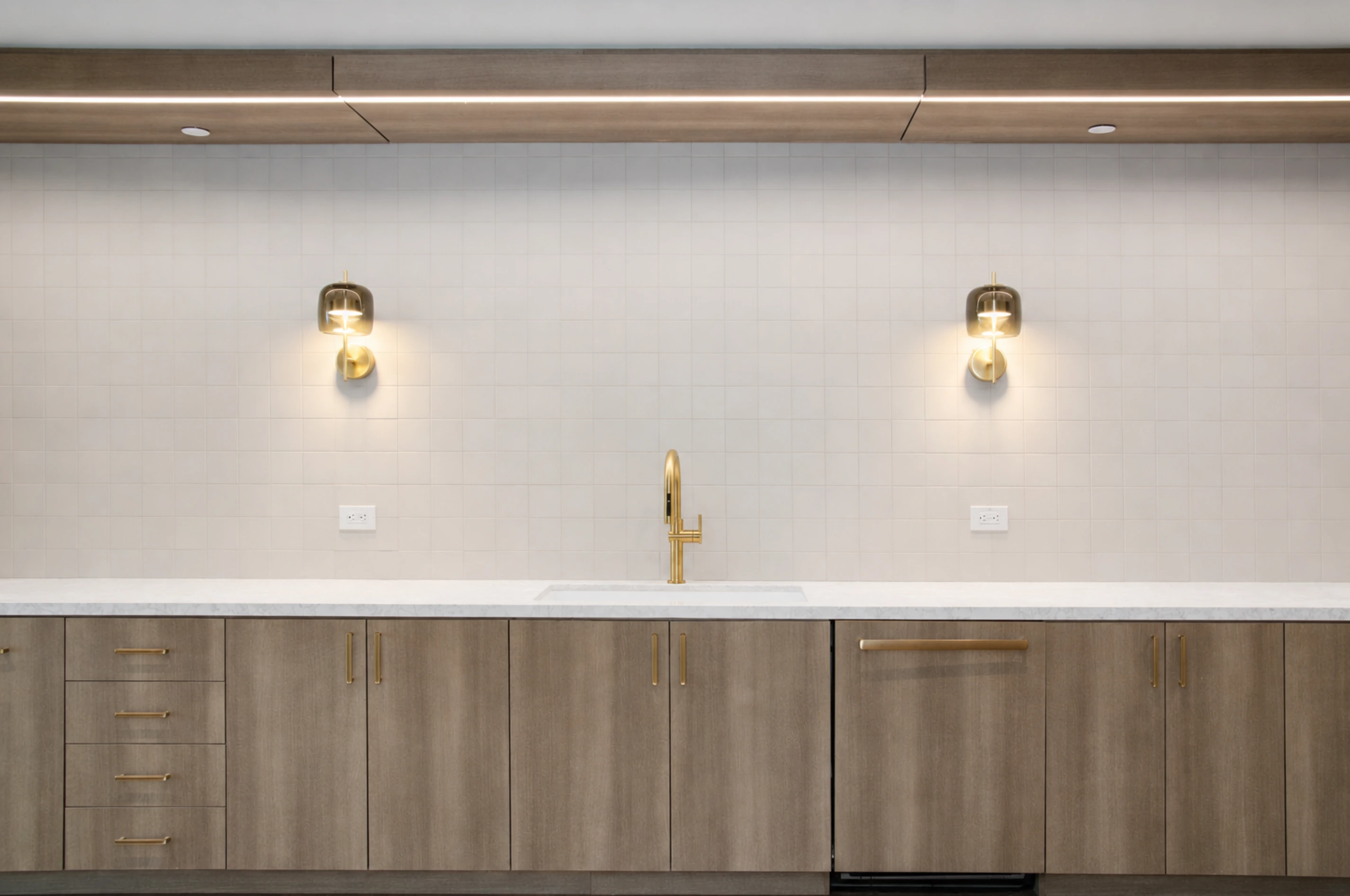 Custom millwork cabinetry, countertop, and tiled backsplash